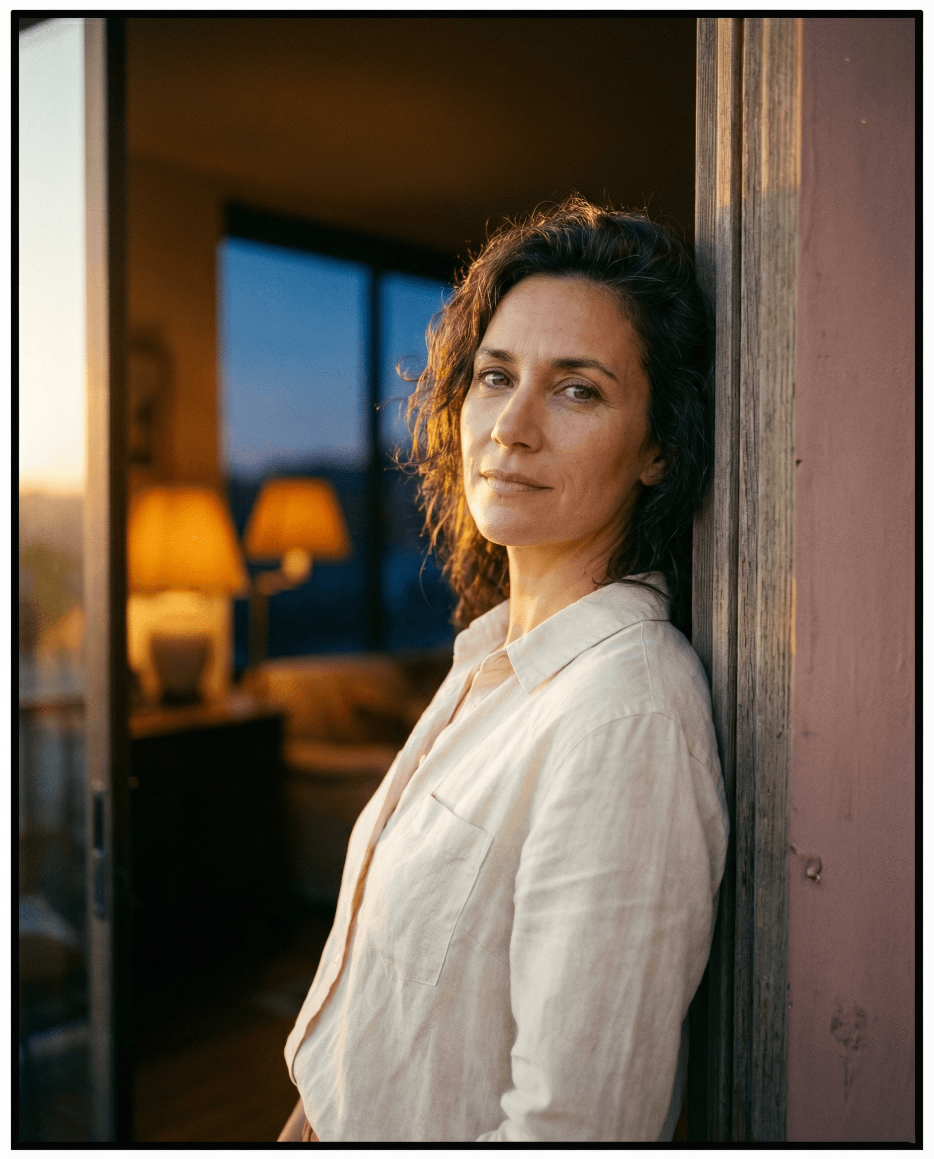 Confident woman in dramatic studio lighting with bold editorial aesthetic